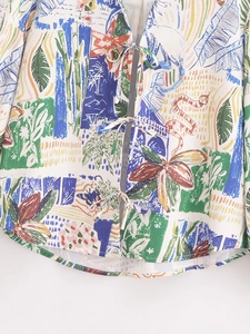 Close-up of colorful floral and abstract pattern on lightweight tie-front blouse