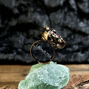 Vintage bronze adjustable ring with irregular red raw stone in a bohemian style