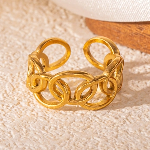 Detailed view of intertwined golden rings on a matte stone base with silk texture