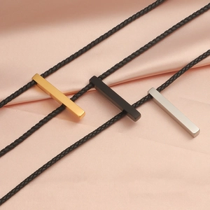 Three rectangular bar pendants in gold, silver and black on woven leather cord necklaces