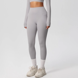Detail of high waisted yoga leggings with side pockets in breathable grey brushed fabric