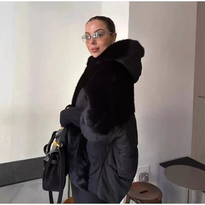 Detail of hooded winter jacket featuring black fur trim panels and quilted hem design