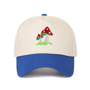 Detailed view of mushroom embroidery and contrast color stitching on the baseball cap