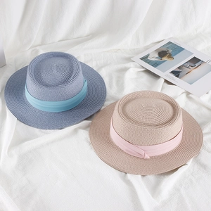 Women's straw boater sun hats in beige and blue featuring elegant silk ribbon accents