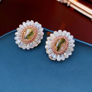 Vintage crystal flower earrings with pink diamonds and a central botanical element