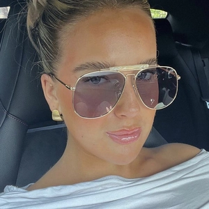Lifestyle detail of stylish double-bridge aviator sunglasses with gradient purple lenses
