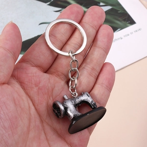 Retro sewing machine keychain in antique silver finish with metal keyring and black base