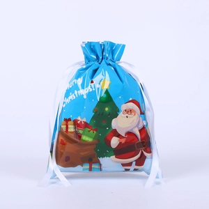 Blue drawstring gift bag featuring festive Merry Christmas prints and white ribbons