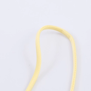 Macro view of adjustable yellow silk fabric shoulder strap with neat stitching detail