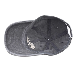 Close-up of coconut tree embroidery on the brim of a washed cotton baseball cap