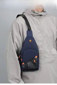 Detail of blue men's chest bag with camouflage patterns and vibrant orange zipper pulls