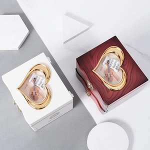 Classic music box with heart-shaped window and miniature cello model inside