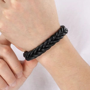 Close-up of black braided microfiber leather bracelet with magnetic clasp on wrist