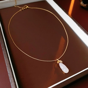 Detail of gold plated necklace with white chalcedony eggplant pendant and fine O-chain
