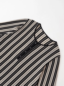 Detailed close-up of striped knit fabric texture with henley collar and small buttons