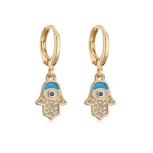 Detailed view of gold plated Hamsa hand earrings with blue enamel and white zircon stones