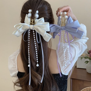 Elegant bow hair claw clip with faux pearl tassels in cream white and light purple fabric