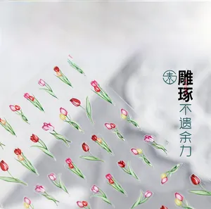 Close-up of tulip flower nail art stickers with red pink and yellow floral designs