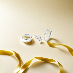 Detailed macro view of a 3-piece S925 silver earring set with turquoise on gold silk