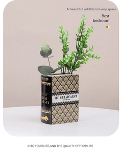Detailed view of book-shaped ceramic vase featuring The Great Gatsby gold art deco motifs