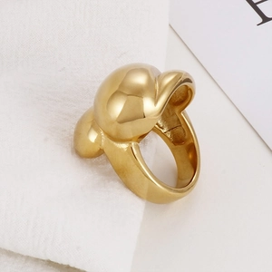 Detail of a thick gold stainless steel ring with a smooth polished fishnet wave pattern