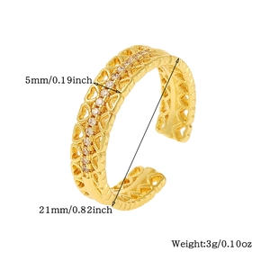 Detail view of golden open ring with heart cutouts and zircon showing dimensions and weight