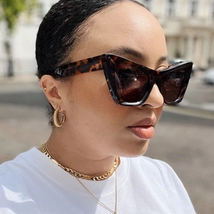 Fashionable women's cat-eye tortoiseshell sunglasses with dark lenses and UV protection