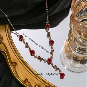 Detail of red rose necklace with dimensions 41cm plus 6.2cm and weight 8.3g on gold frame