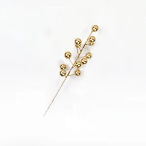 Detail view of artificial 12-head metallic gold Christmas berries branch for holiday decor