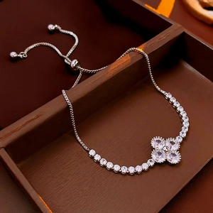 Macro view of adjustable silver flower bracelet with sparkling white zircons in a box