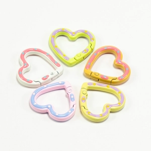 Five colorful heart-shaped spring ring carabiners with polka dots for DIY keychains