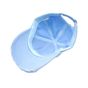Distressed light blue cotton baseball cap with ripped brim detail and vintage washed style