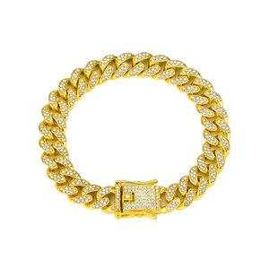 Close-up of golden Cuban link bracelet with sparkling rhinestones and a secure buckle