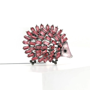 Charming hedgehog brooch with vibrant pink crystals and silver metal finish