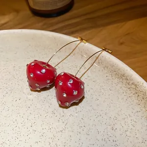 Elegant strawberry dangle earrings with red resin and sparkling white rhinestones