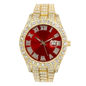 Macro view of iced-out gold watch with red dial and roman numeral date display