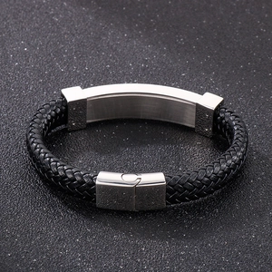 Detail of black braided leather bracelet with brushed stainless steel magnetic clasp