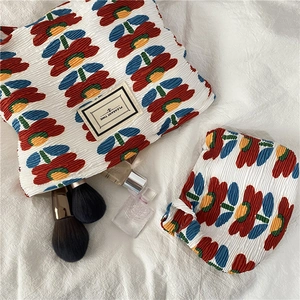 Detail showing floral pleated chiffon toiletry bag set with tulip pattern and zipper closure