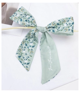 Detail of floral silk scarf hair tie in mint green with Green Inspiration text