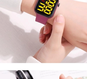 Detail view of purple silicone strap and square LED digital display on sports watch