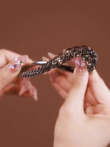 Close-up of a sparkling rhinestone twist hair clip featuring vintage luxury design