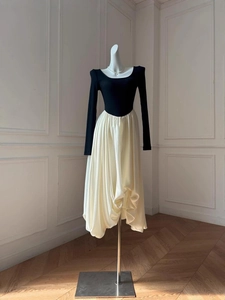 Slim fit two-tone dress featuring a black long sleeve top and beige pleated balloon skirt