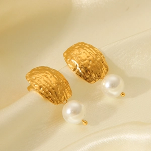 Hammered gold square studs with white pearl drops on elegant beige silk background