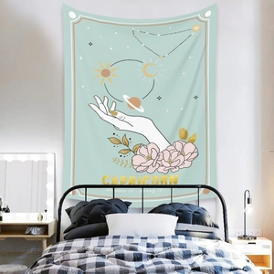 Detail of bohemian Capricorn constellation tapestry on a bedroom wall with warm lighting