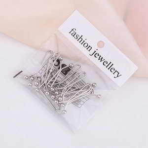 Detailed view of silver U-shaped metal scarf clips set in fashion jewelry packaging
