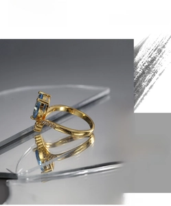 Macro detail of a vintage teardrop blue zircon ring with small diamonds on gold band