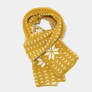Detail of ginger winter knit scarf featuring white Nordic snowflake patterns