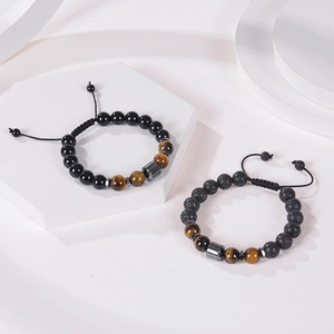 Adjustable 10mm tiger eye and lava stone bead bracelets set on white geometric display
