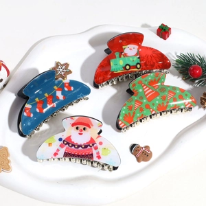 Set of 4 Christmas hair claws with Santa and festive prints on white tray