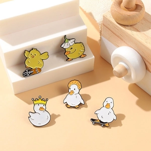 Cute cartoon duck enamel pins set featuring skateboard, crown, and floral hat designs